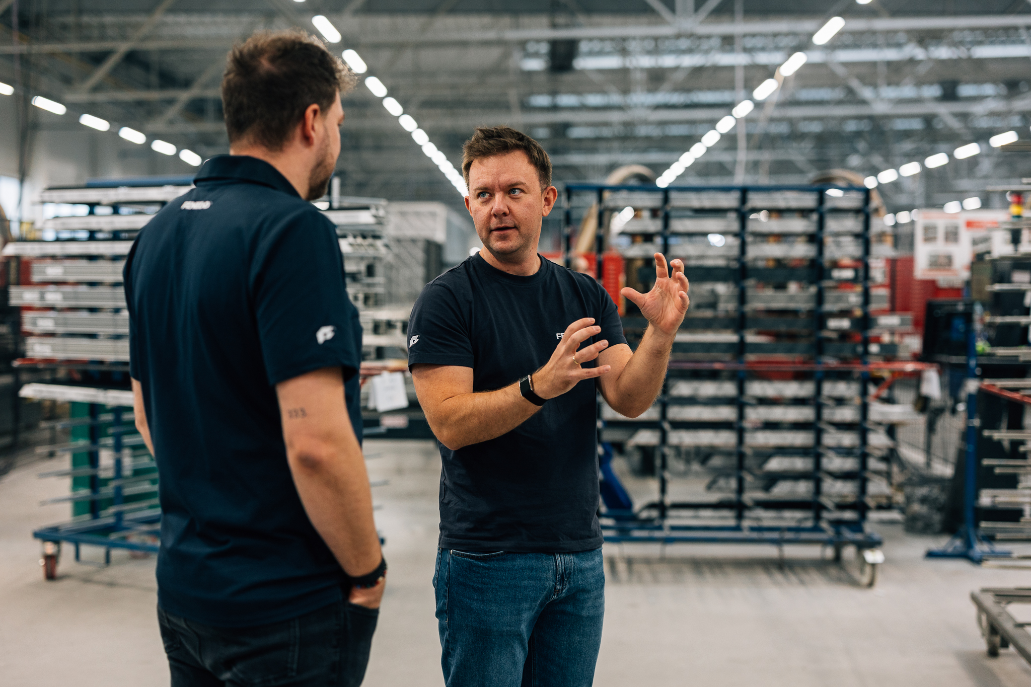 FENEDO team discussing production in factory